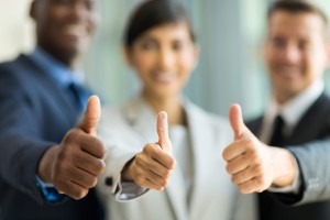 close up of multiracial business team giving thumbs up